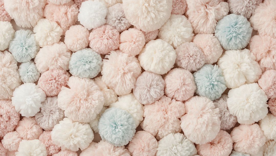 Pastel Yarn Pompoms Creating Soft Textured Background for Nursery Decor and Crafts