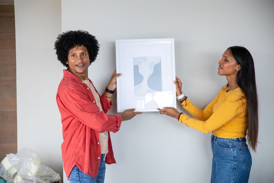 Couple Aligning Abstract Art in Modern Inter