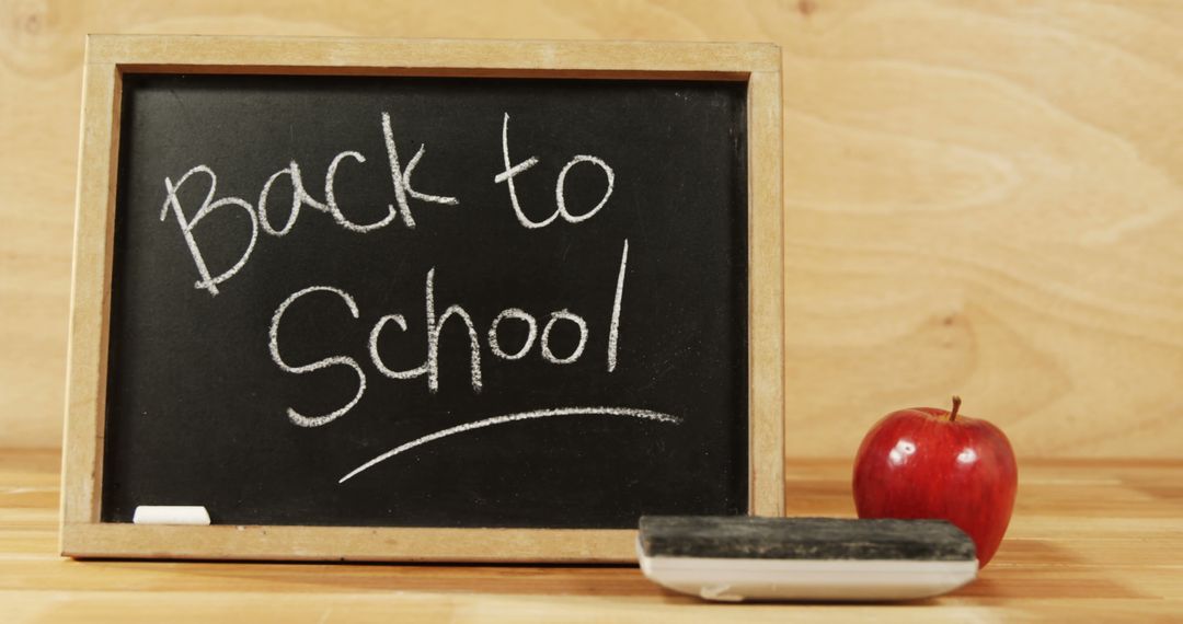Back to School Chalkboard with Red Apple and Chalk