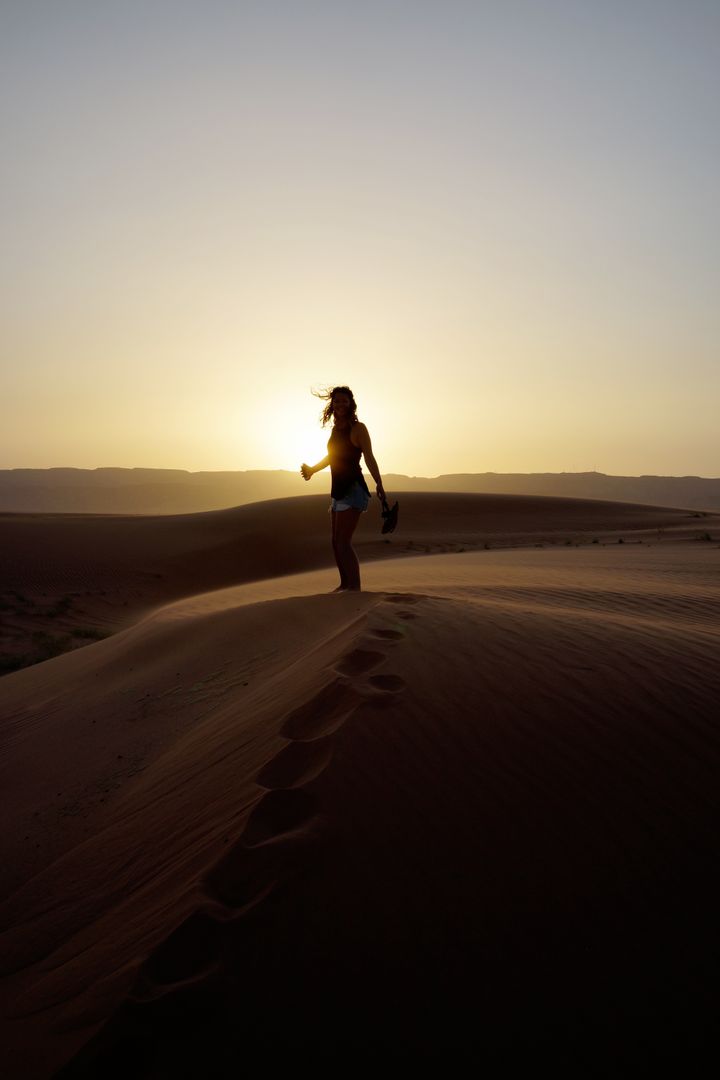 Silhouette of Woman Standing on Dessert during Sunset - Free Images, Stock Photos and Pictures on Pikwizard.com
