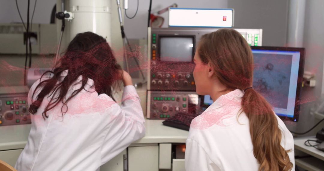Female Researchers Operate Scanning Electron Microscope in Lab