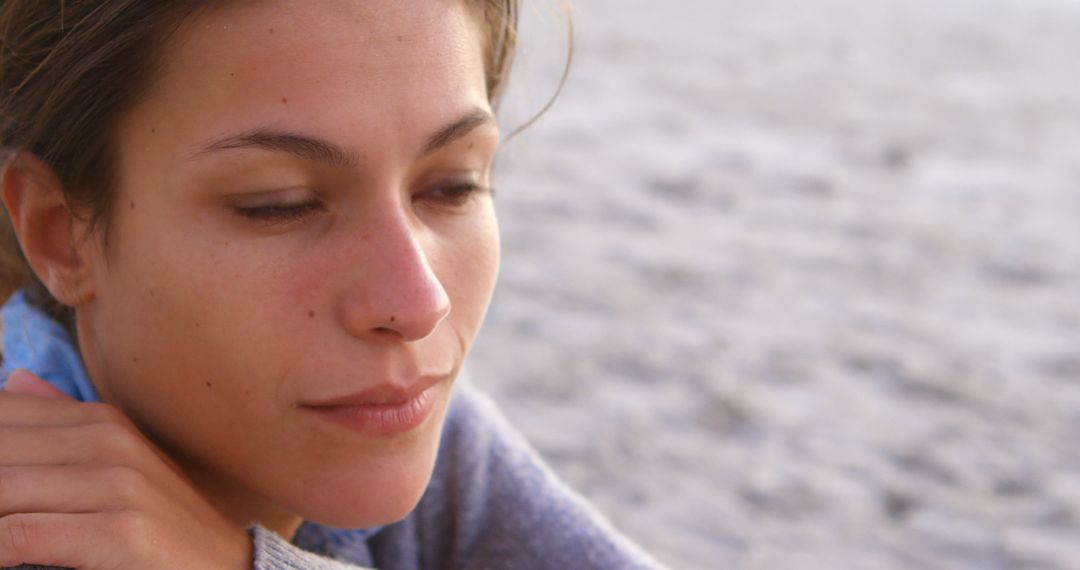 Woman Relaxing by Ocean with Serene Expression - Free Images, Stock Photos and Pictures on Pikwizard.com