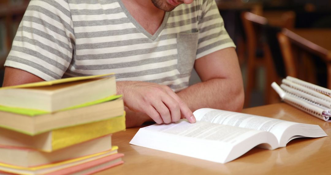 Male Student Studying with Books in Library - Free Images, Stock Photos and Pictures on Pikwizard.com