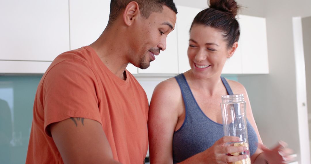 Diverse Couple Making Smoothie Together in Modern Kitchen