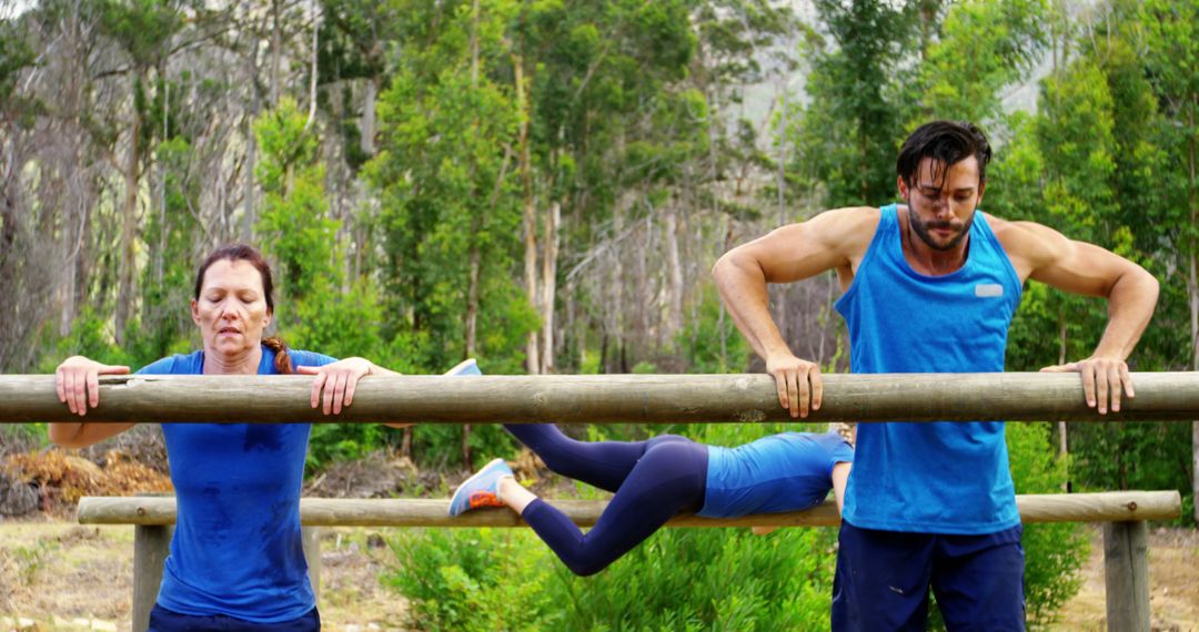 Outdoor Fitness Enthusiasts Performing on Wooden Bars in Nature - Free Images, Stock Photos and Pictures on Pikwizard.com