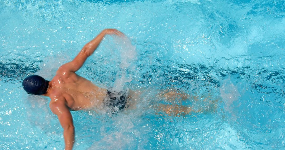 Swimmer Performing Front Crawl in Blue Pool - Free Images, Stock Photos and Pictures on Pikwizard.com