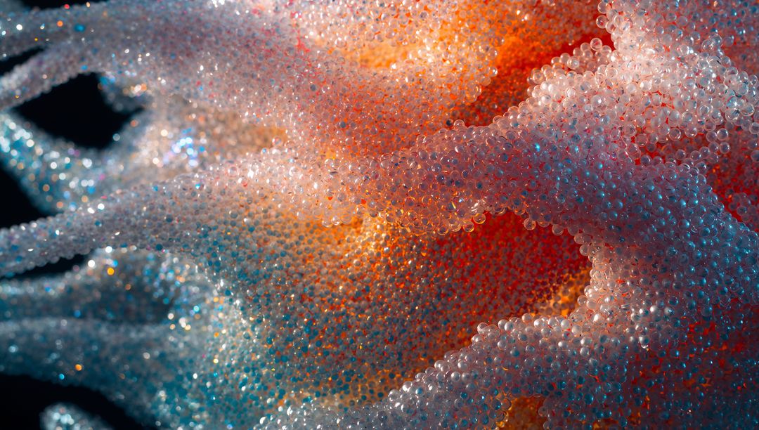 Translucent Microbead Waves Glowing in Iridescent Orange Pink Blue Macro Texture