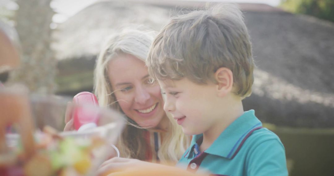 Mother and Son Adding Ketchup at Backyard Gathering
