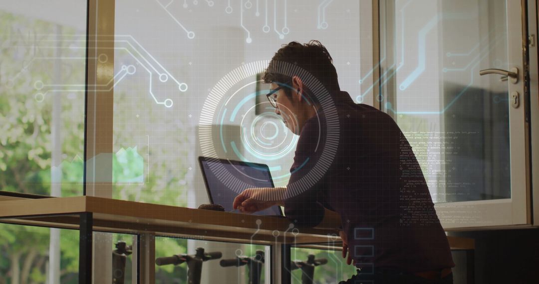 Man Working on Laptop with Digital Interface Overlay