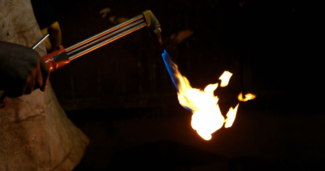 Blacksmith using acetylene torch with intense flame in workshop - Free Images, Stock Photos and Pictures on Pikwizard.com