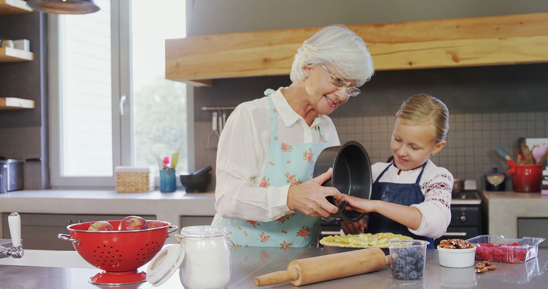 Grandmother and Young Girl Baking Together in Modern Kitchen - Free Images, Stock Photos and Pictures on Pikwizard.com