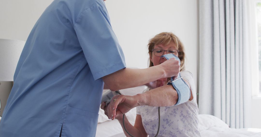 Nurse Checking an Elderly Woman's Blood Pressure at Home - Free Images, Stock Photos and Pictures on Pikwizard.com