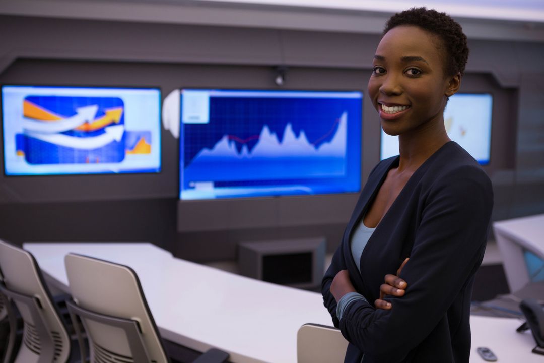 Confident African American Woman in Control Room with Data Screens