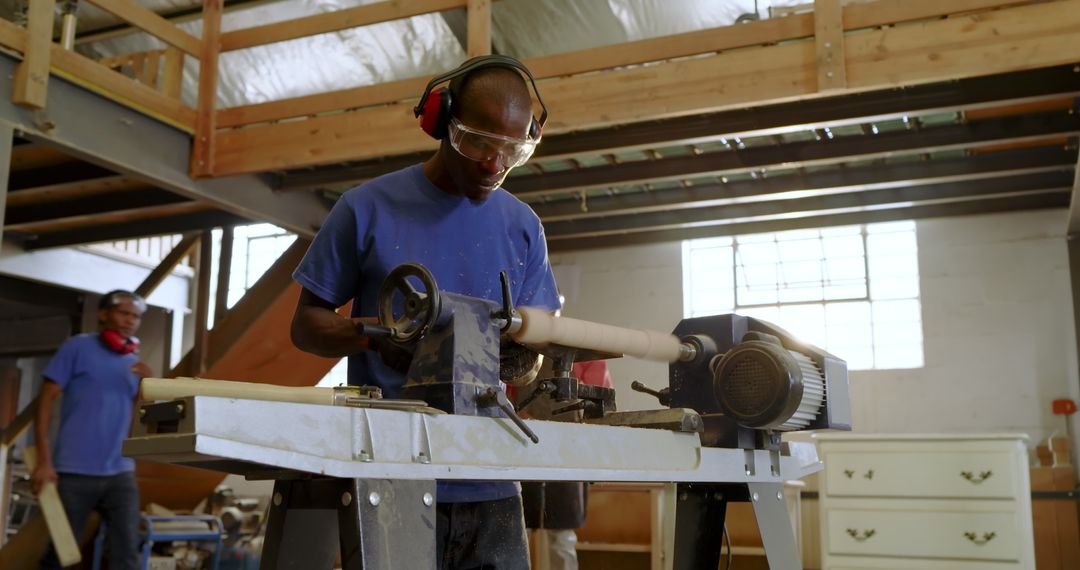 Craftsman Operating Lathe in Workshop While Wearing Safety Gear