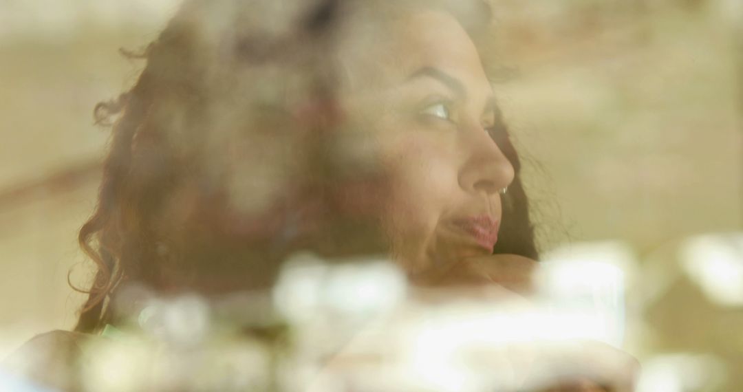 Thoughtful African American woman looking out window, reflecting on life - Free Images, Stock Photos and Pictures on Pikwizard.com