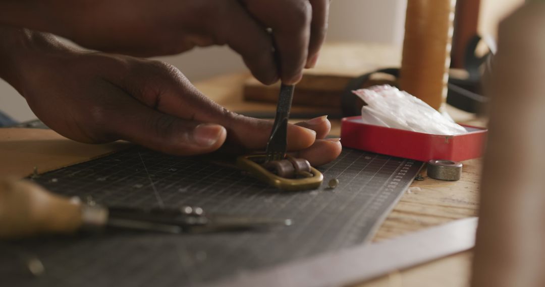 Leather Craftsman Handcrafting Belt Detail in Workshop