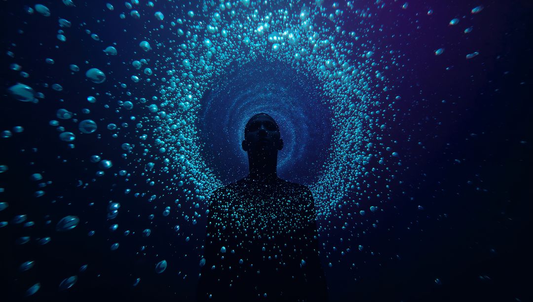 Floating Male Silhouette Drifting Through Luminous Bubble Vortex in Deep Blue