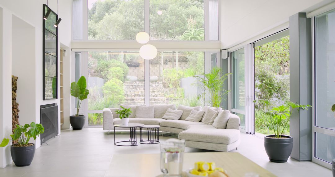 Sunlit Minimalist Living Room with L-Shaped Sectional Sofa and Floor-to-Ceiling Windows