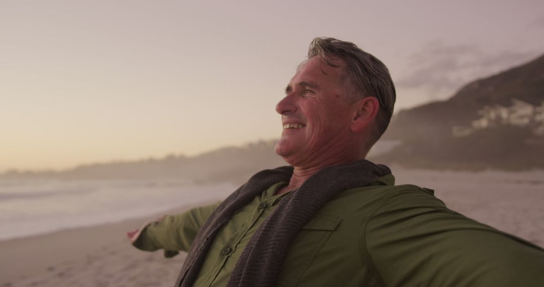 Happy Senior Man Enjoying Sunset at Beach - Free Images, Stock Photos and Pictures on Pikwizard.com