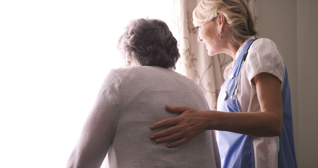 Nurse Assisting Elderly Woman Looking Through Window - Free Images, Stock Photos and Pictures on Pikwizard.com