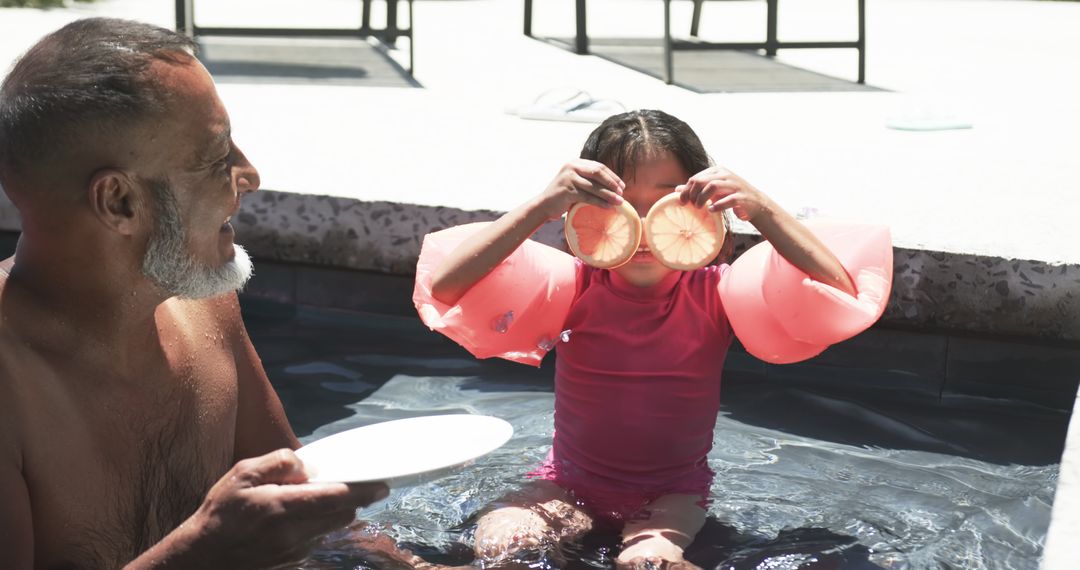 Playful Poolside Family Moment with Grapefruit Slices