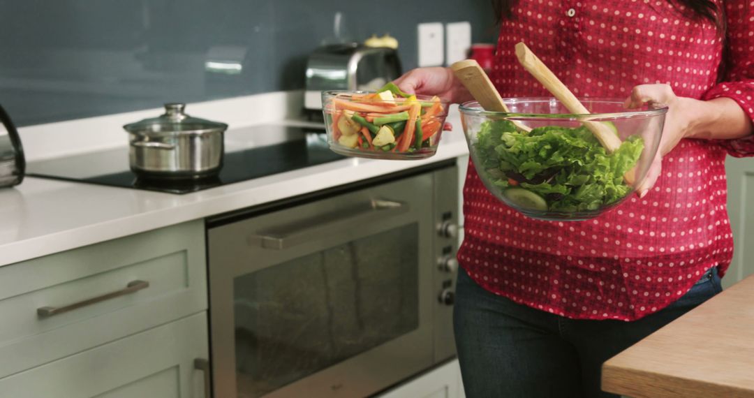 Woman Preparing Fresh Garden Salad and Vegetable Stir-Fry in Modern Kitchen - Free Images, Stock Photos and Pictures on Pikwizard.com