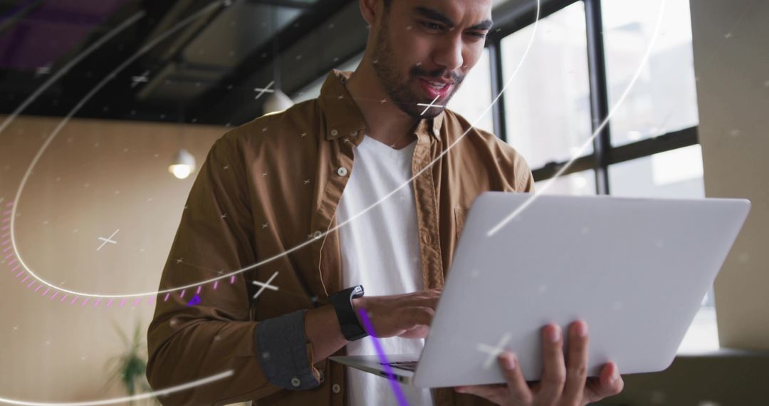 Focused Developer Working on Laptop in Modern Office