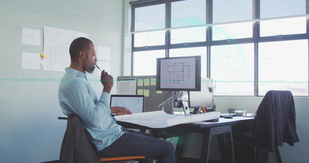 Architect Analyzing Blueprint in Modern Studio Environment