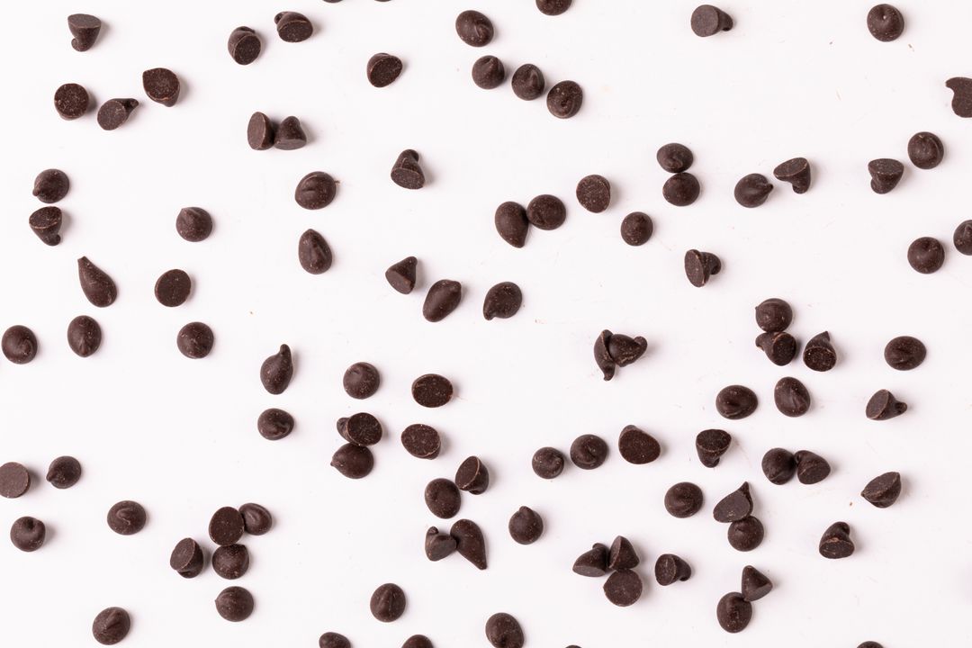Overhead view of chocolate chips on white background, copy space - Free Images, Stock Photos and Pictures on Pikwizard.com