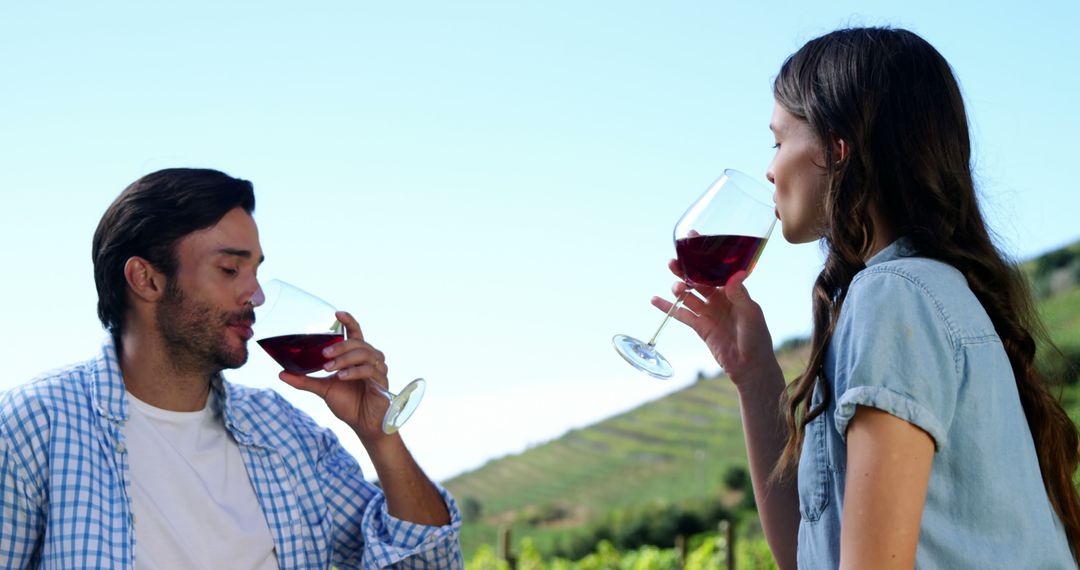 Couple Enjoying Wine Tasting in Vineyard Scenery