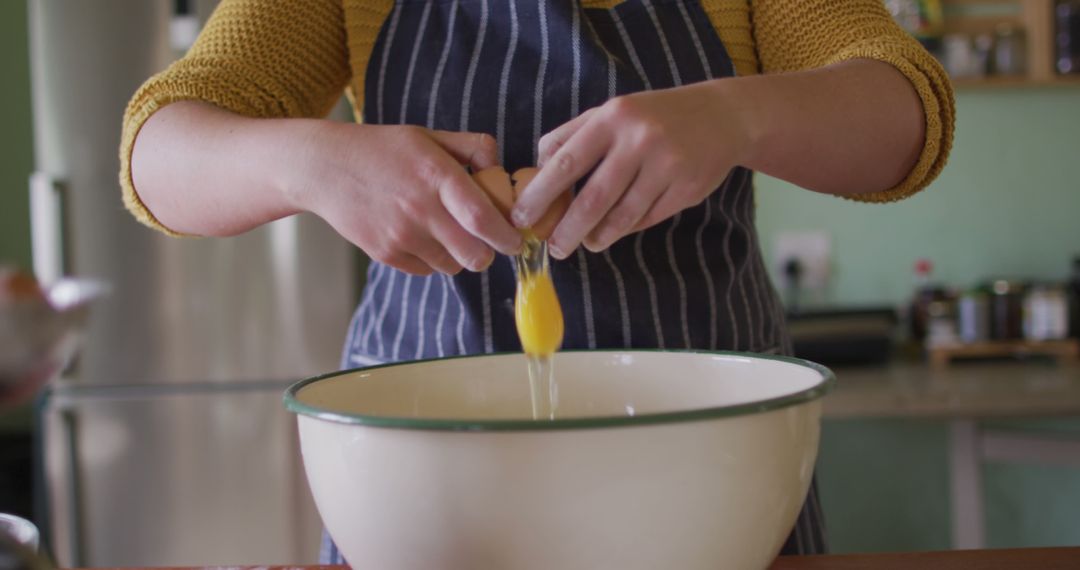 Close-Up of Woman Cracking Egg in Mixing Bowl - Free Images, Stock Photos and Pictures on Pikwizard.com