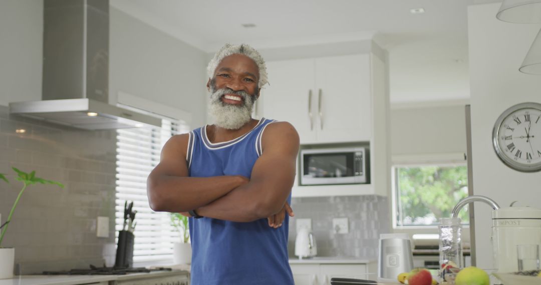 Smiling Elderly Man Cooking in Bright Modern Kitchen - Free Images, Stock Photos and Pictures on Pikwizard.com