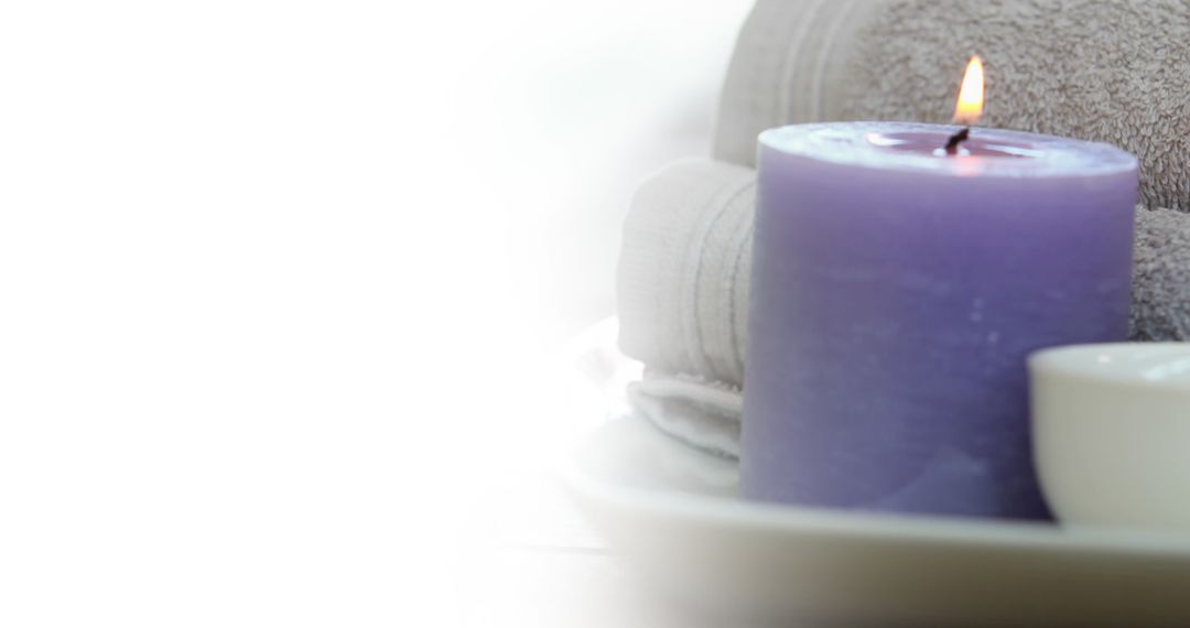 Purple Candle and Soft Towels for Relaxation Spa Theme