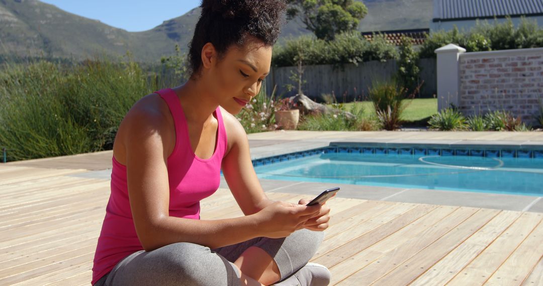 Woman Checking Smartphone by Swimming Pool after Exercise - Free Images, Stock Photos and Pictures on Pikwizard.com