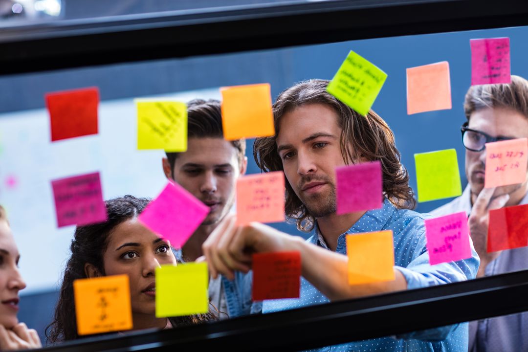 Creative Team Collaborating with Colorful Post-Its in Office