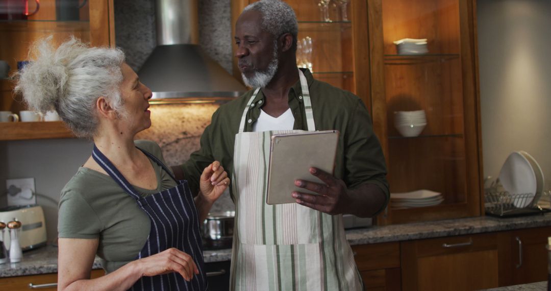 Biracial Couple Cooking Together in Modern Kitchen with Tablet
