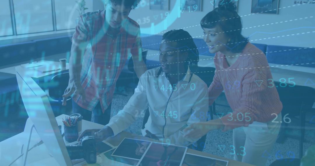 Diverse Team Analyzing Data on Computer in Modern Office