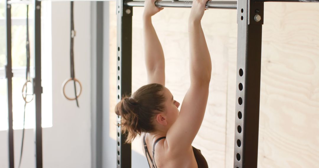 Female Athlete Performing Pull-Up Exercise in Gym - Free Images, Stock Photos and Pictures on Pikwizard.com