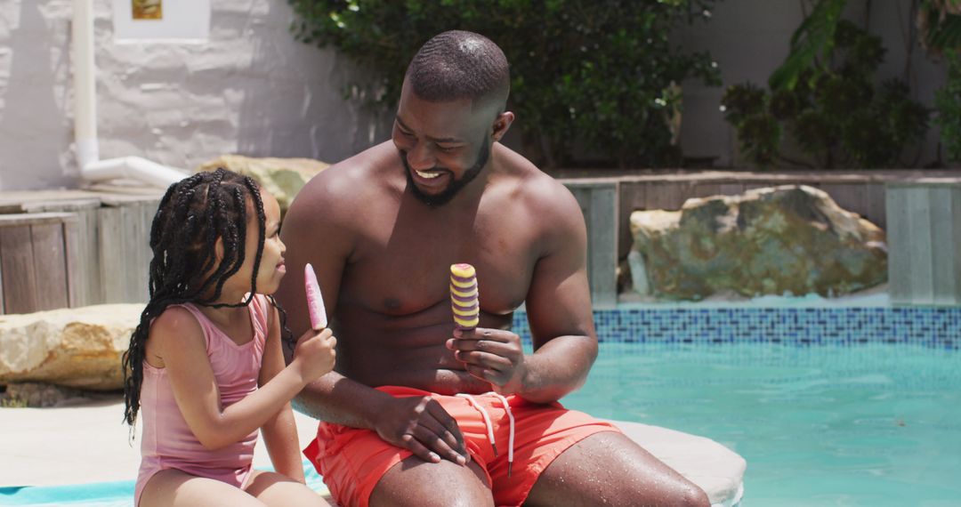 Father and Daughter Enjoying Ice Cream by Poolside
