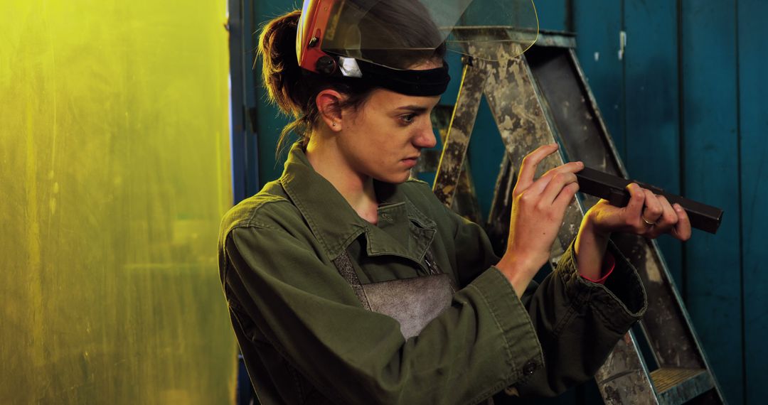 Female metalworker inspecting metal bar in workshop - Free Images, Stock Photos and Pictures on Pikwizard.com