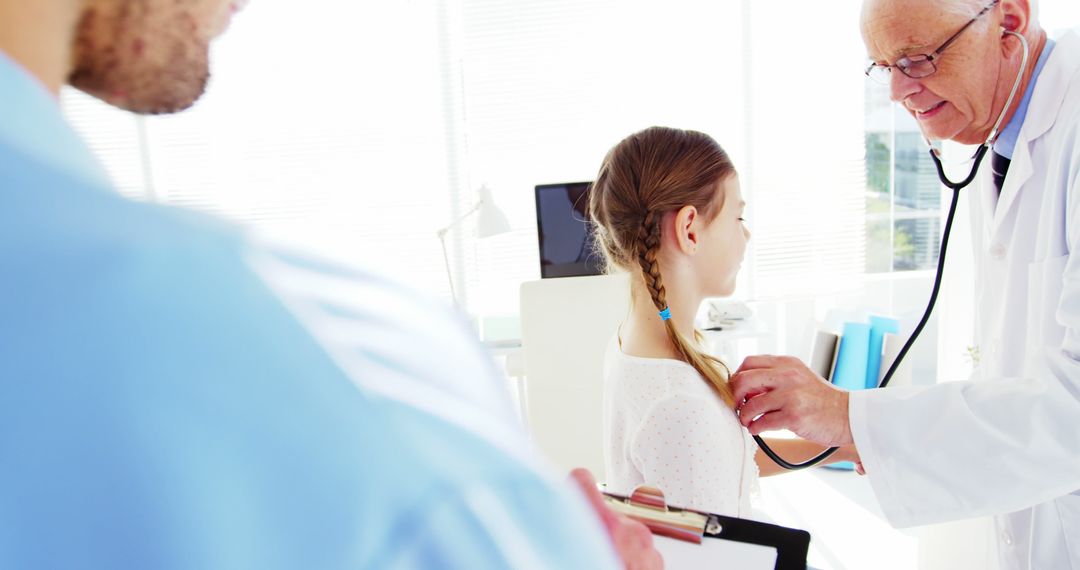 Doctor Examining Young Girl with Stethoscope in Clinic - Free Images, Stock Photos and Pictures on Pikwizard.com