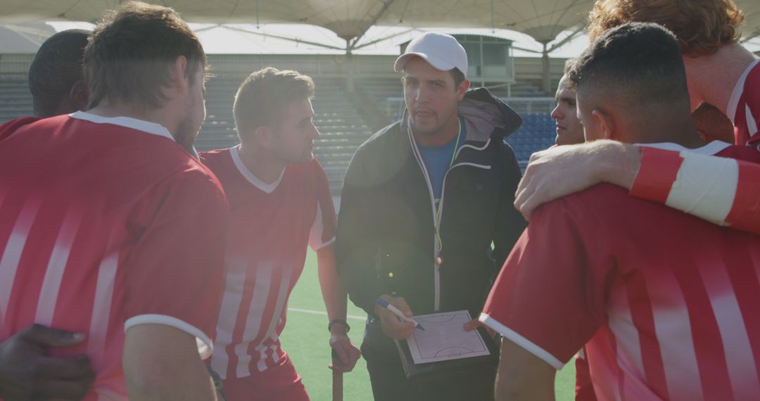 Sports Coach Encouraging Soccer Players During Half-time Huddle on Field - Free Images, Stock Photos and Pictures on Pikwizard.com