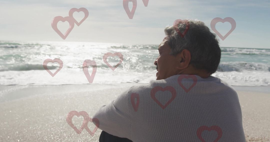 Elderly Man Reflecting on Serene Beach with Heart Overlays