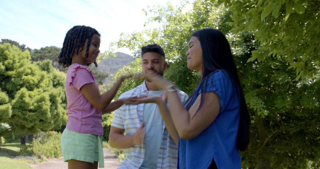 Family Enjoying Hand Clapping Game in Scenic Park