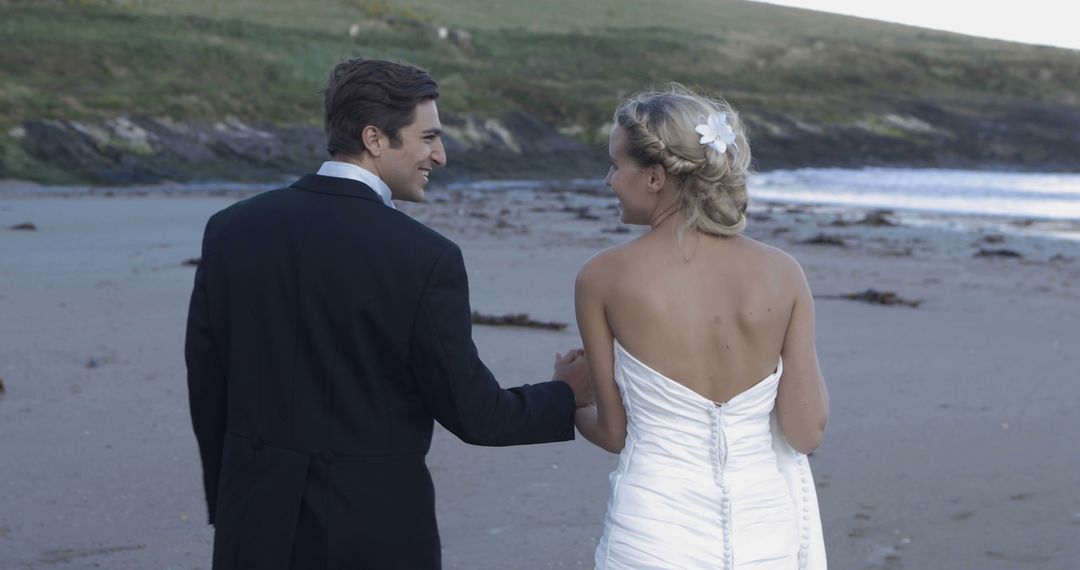 Bride and Groom Walking on Beach During Wedding Day - Free Images, Stock Photos and Pictures on Pikwizard.com