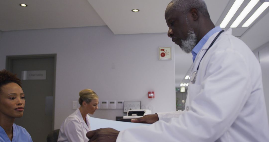 Diverse Medical Team Collaborating in Hospital Station - Free Images, Stock Photos and Pictures on Pikwizard.com