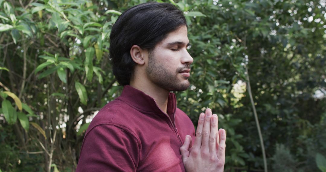 Young Man Meditating Outdoors in Lush Greenery - Free Images, Stock Photos and Pictures on Pikwizard.com