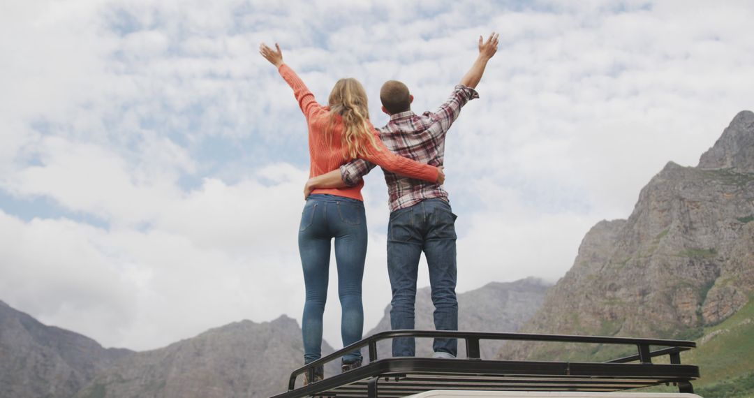 Couple Embracing on Top of Vehicle, Enjoying Mountain View - Free Images, Stock Photos and Pictures on Pikwizard.com