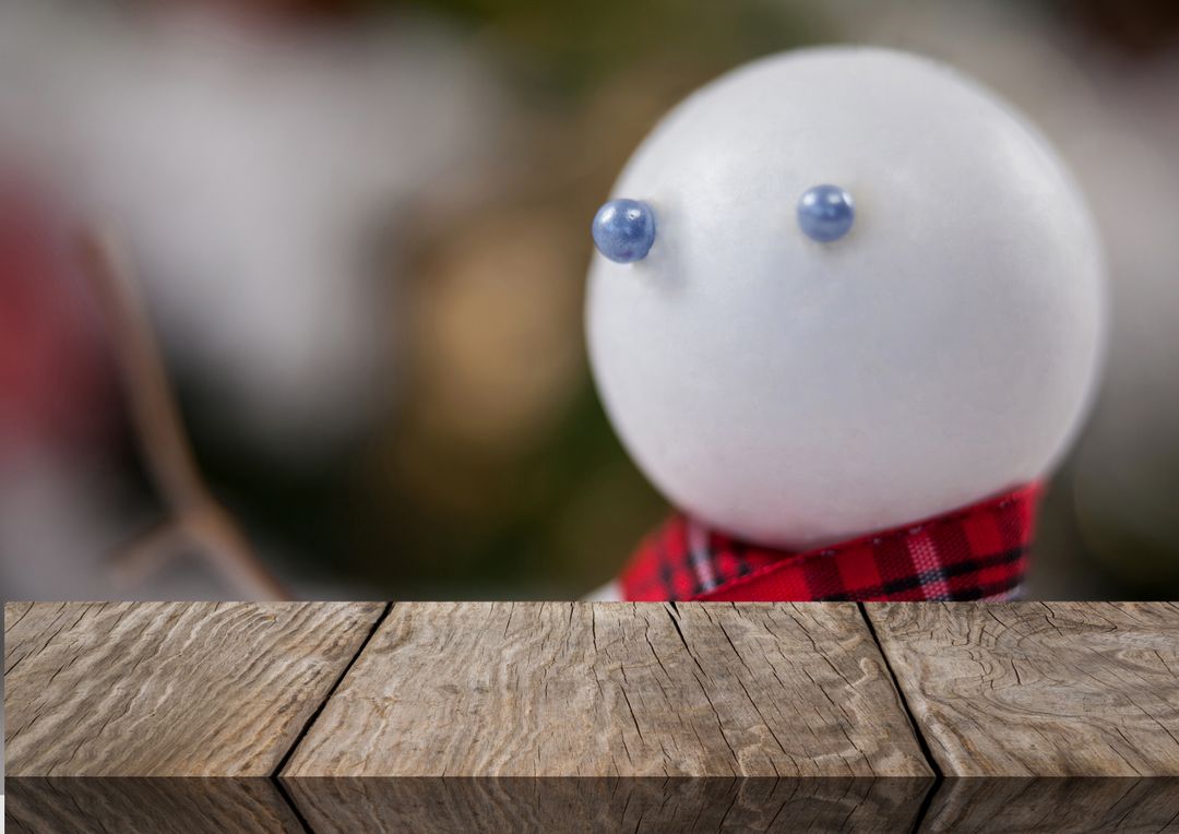 Close-Up of Snowman Statue by Blank Wooden Table with Copy Space - Free Images, Stock Photos and Pictures on Pikwizard.com