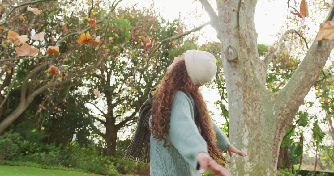 Woman Enjoying Autumn in Park with Arms Outstretched - Free Images, Stock Photos and Pictures on Pikwizard.com